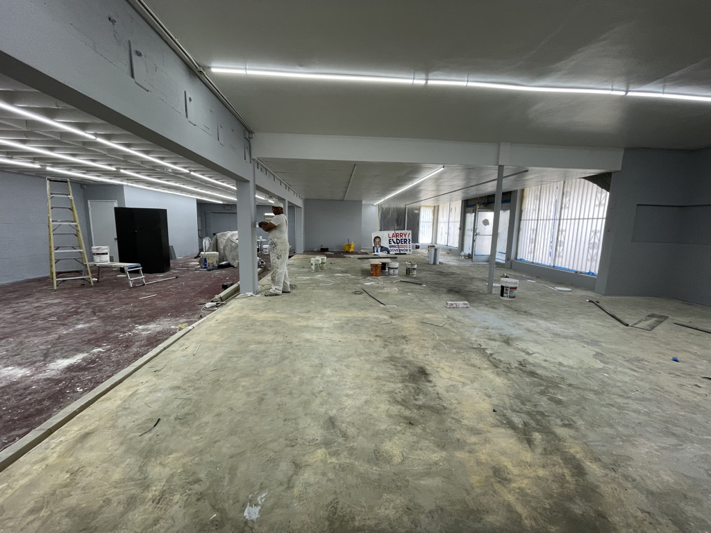 03 · Former retail floor facing the storefront windows · Before the 2024–2026 conversion