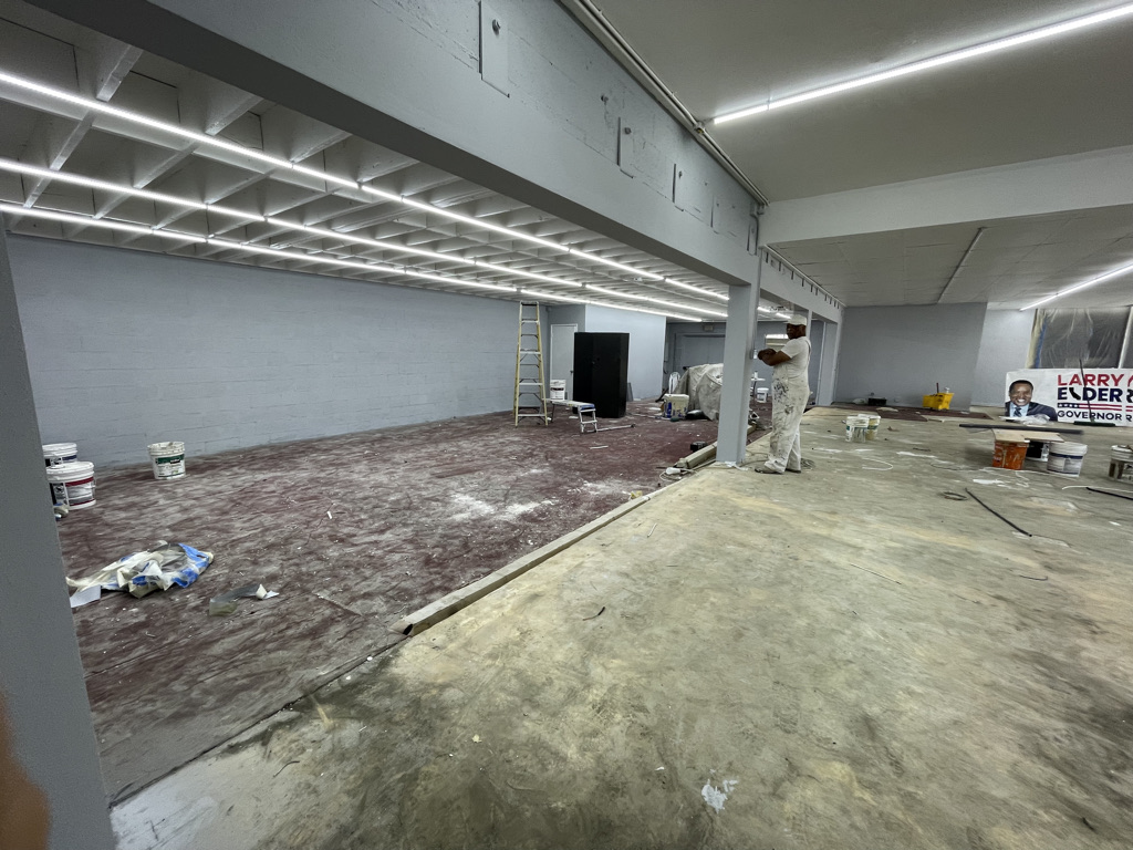 02 · Main retail floor and exposed ceiling beams · Before the 2024–2026 conversion